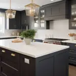 Dark charcoal kitchen cabinets with gold hardware showing a cabinet refacing vs refinishing comparison result in a modern Metro Detroit kitchen.