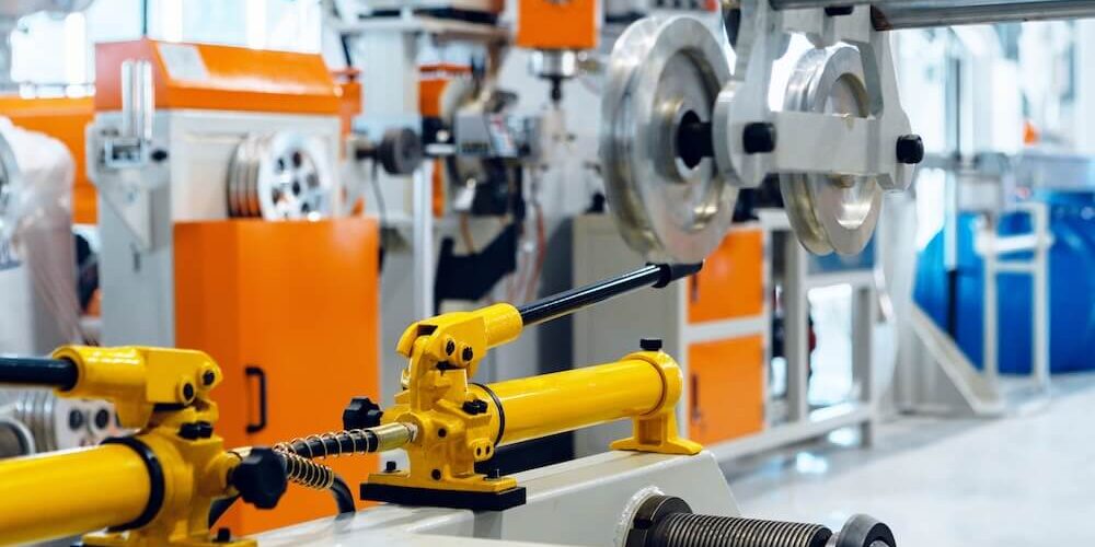 Industrial machinery painting protecting metal equipment components in a manufacturing facility